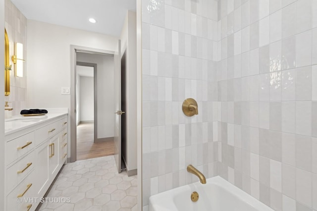 bathroom featuring tiled shower / bath combo, vanity, and tile patterned floors