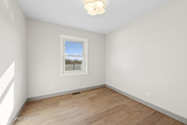 unfurnished room with light hardwood / wood-style flooring