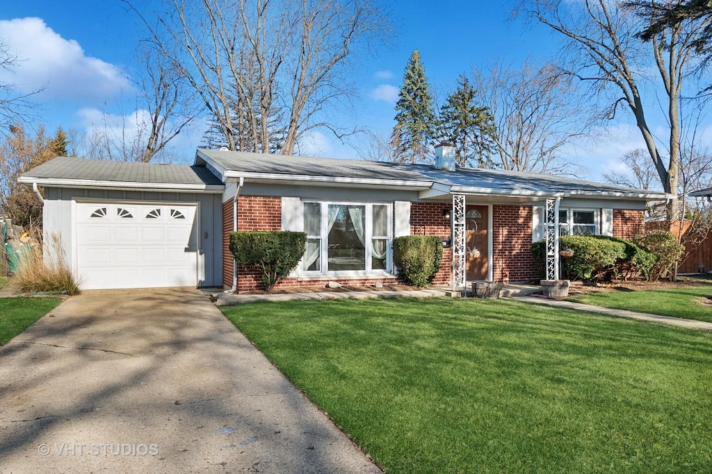 ranch-style home featuring a front yard and a garage