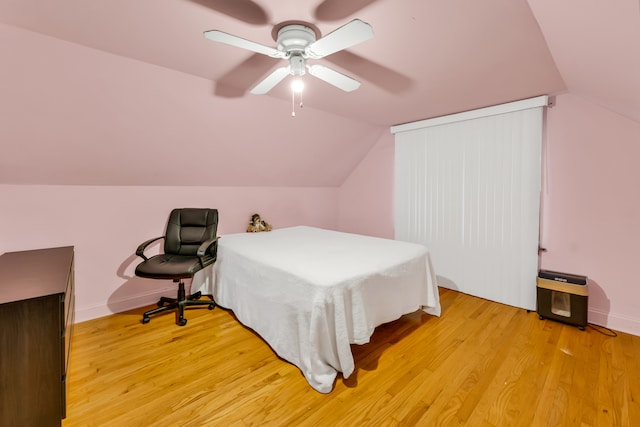 bedroom featuring light hardwood / wood-style floors, ceiling fan, and lofted ceiling