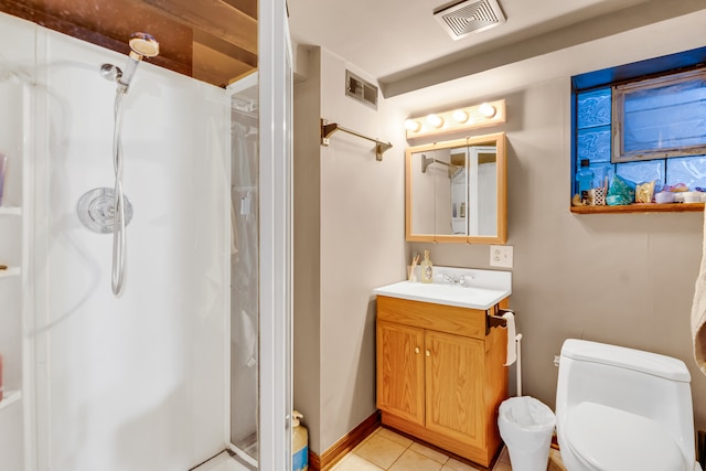 bathroom featuring walk in shower, vanity, toilet, and tile patterned flooring