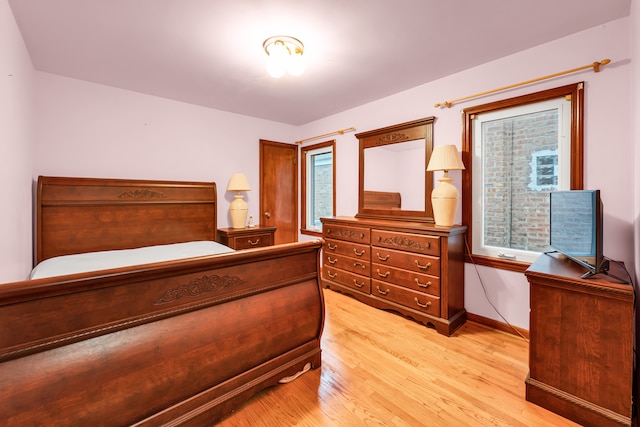 bedroom featuring multiple windows and light wood-type flooring