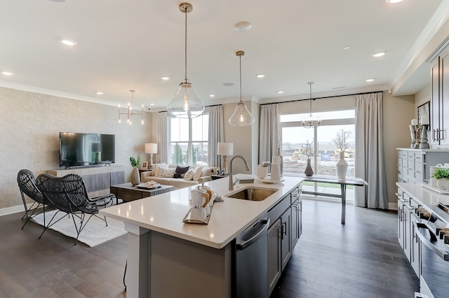 kitchen featuring pendant lighting, a center island with sink, dark wood-type flooring, and sink