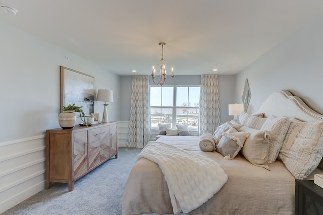 carpeted bedroom featuring an inviting chandelier