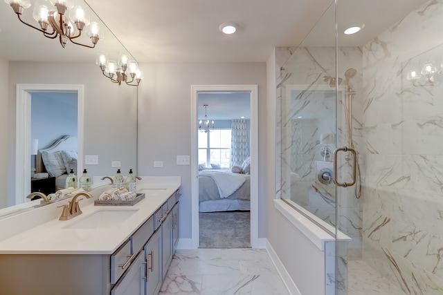 bathroom with a shower with shower door, vanity, and an inviting chandelier