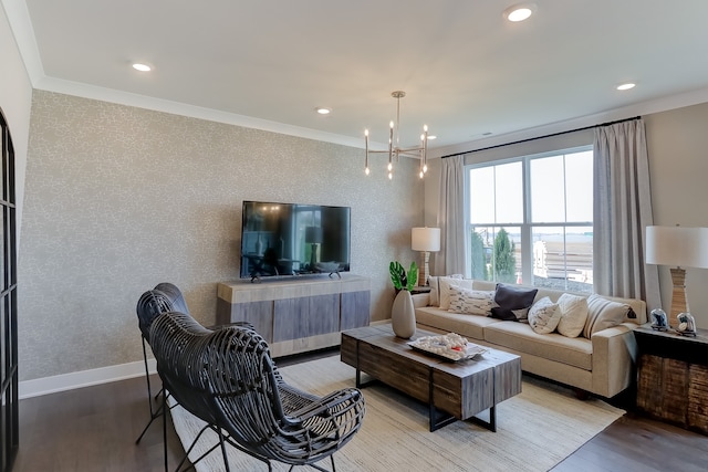 living room with wood-type flooring, an inviting chandelier, and crown molding