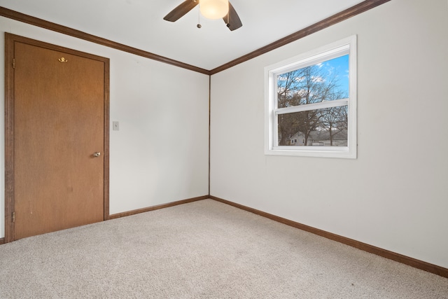 empty room featuring ornamental molding, ceiling fan, and carpet floors