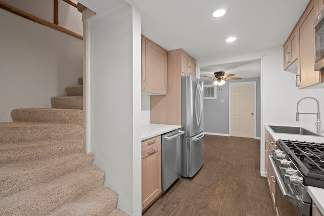 kitchen with sink, appliances with stainless steel finishes, light brown cabinets, ceiling fan, and dark hardwood / wood-style flooring