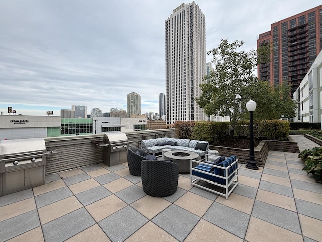 view of patio / terrace with a fire pit and area for grilling