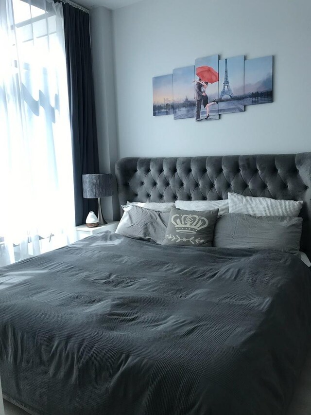 spare room featuring light wood-type flooring and a wall of windows