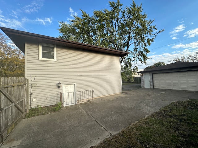 view of side of property featuring a garage and an outdoor structure