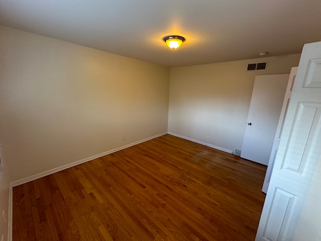 spare room featuring dark hardwood / wood-style floors