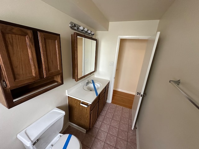 bathroom featuring toilet, vanity, and tile patterned floors