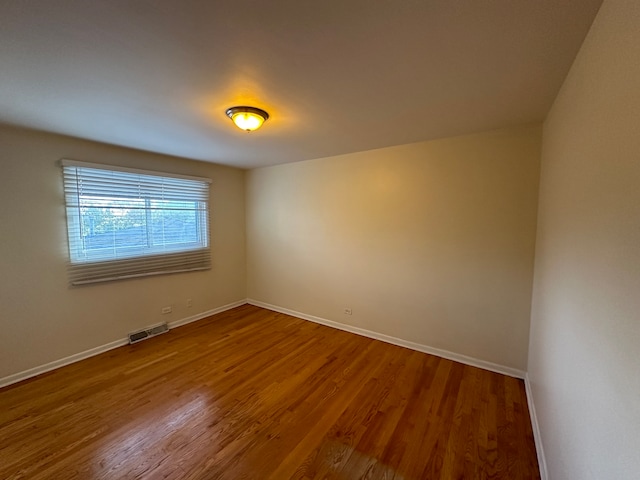 unfurnished room featuring hardwood / wood-style flooring