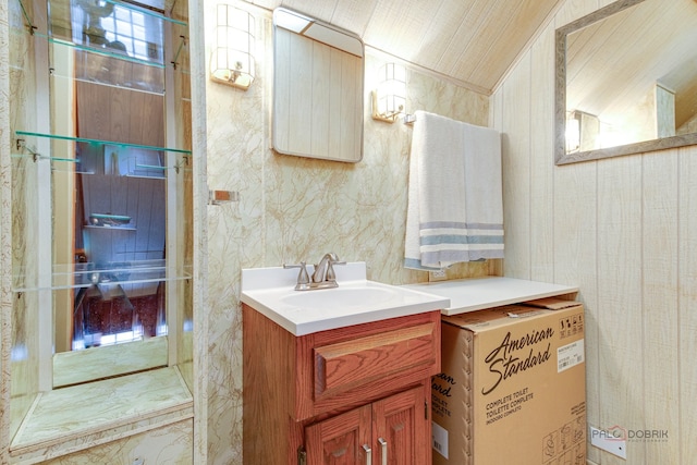 bathroom with vanity and lofted ceiling