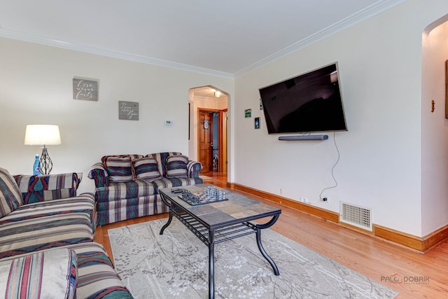 living room with hardwood / wood-style floors and crown molding