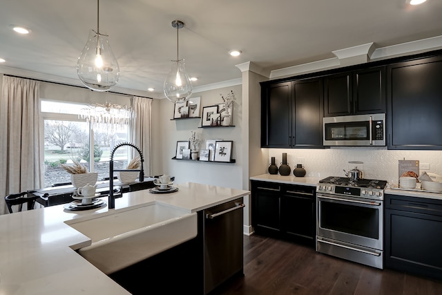 kitchen featuring stainless steel appliances, dark hardwood / wood-style flooring, sink, crown molding, and decorative light fixtures