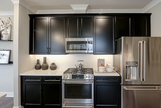 kitchen featuring ornamental molding, hardwood / wood-style flooring, and high quality appliances