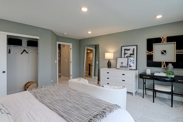 bedroom featuring a closet and light colored carpet