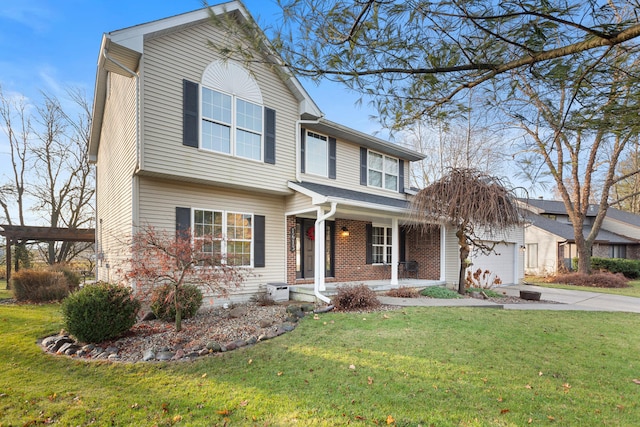 view of front of property featuring covered porch, a garage, and a front lawn