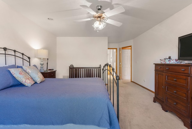 bedroom with ceiling fan and light colored carpet