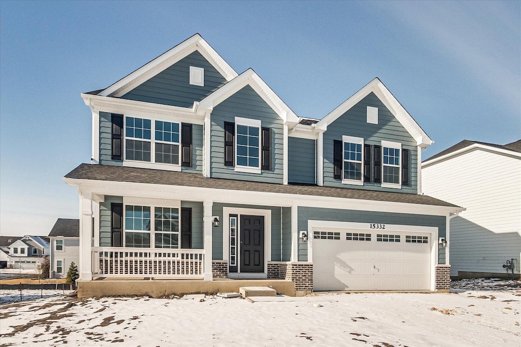 view of front of property featuring a garage and covered porch