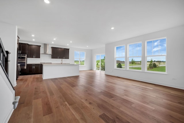 unfurnished living room with hardwood / wood-style floors