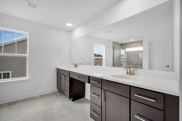 bathroom featuring walk in shower, tile patterned flooring, and vanity