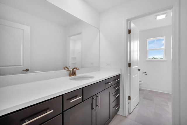 bathroom with toilet and vanity