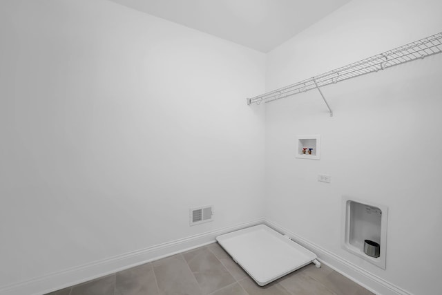 laundry room featuring hookup for a washing machine, light tile patterned floors, and gas dryer hookup