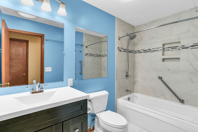 full bathroom featuring toilet, vanity, and tiled shower / bath