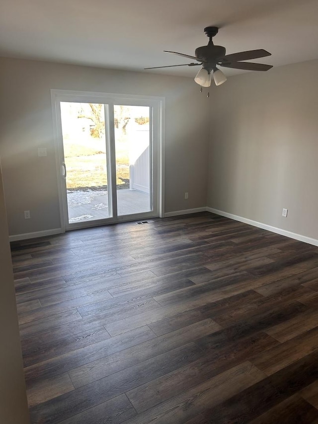 spare room with dark hardwood / wood-style floors and ceiling fan