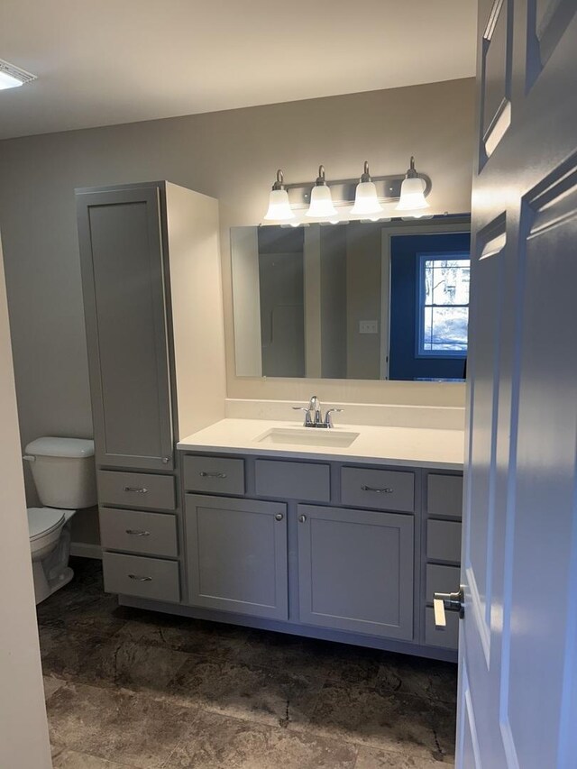 bathroom featuring vanity and toilet