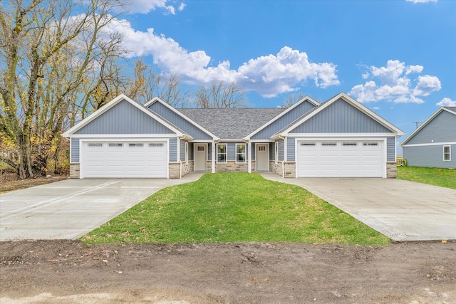 craftsman inspired home with a garage and a front lawn