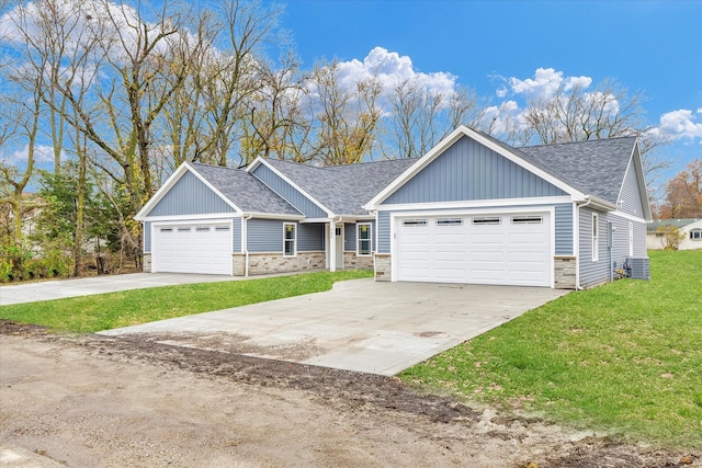 craftsman house with a garage, central AC, and a front lawn