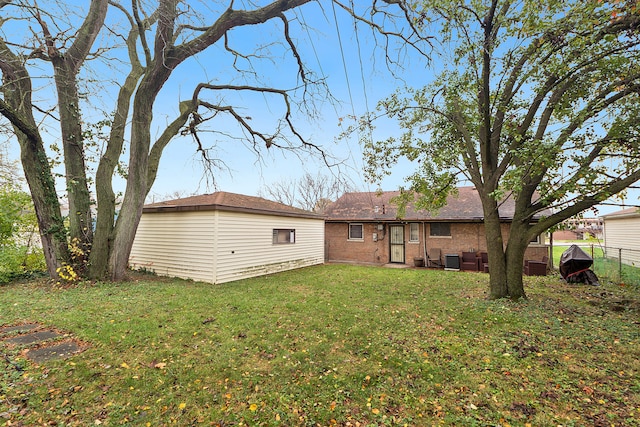 back of property featuring a lawn and central air condition unit