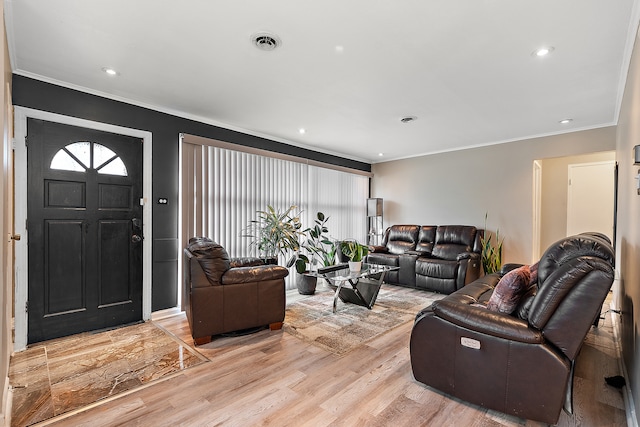 living room featuring ornamental molding and light wood-type flooring