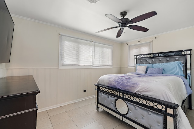 tiled bedroom featuring ceiling fan and ornamental molding