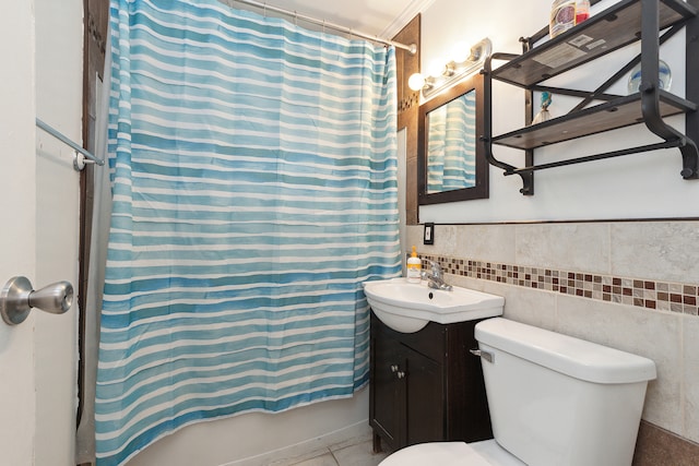 full bathroom featuring crown molding, shower / bath combination with curtain, toilet, vanity, and tile walls