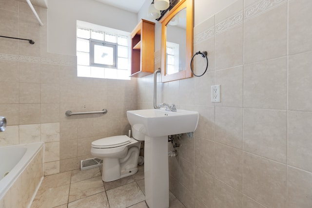 bathroom featuring tile walls and toilet