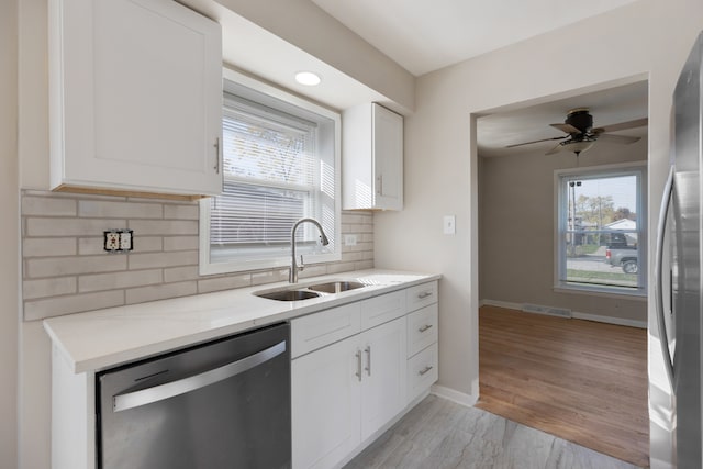 kitchen featuring white cabinetry, sink, a healthy amount of sunlight, and appliances with stainless steel finishes