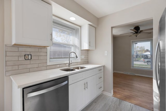 1367 Buffalo Ave, Calumet City, IL 60409 - kitchen with stainless steel appliances, a sink, white cabinets, and plenty of natural light