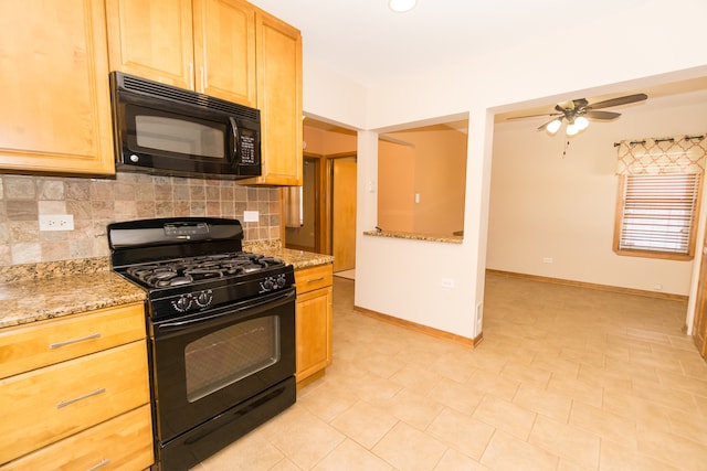 kitchen featuring black appliances, backsplash, and light stone countertops