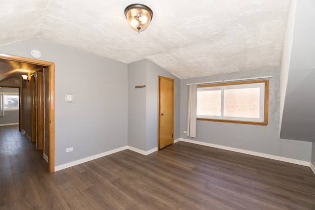 empty room with dark wood-type flooring and plenty of natural light