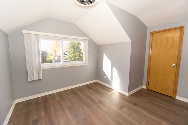 additional living space featuring hardwood / wood-style floors and lofted ceiling