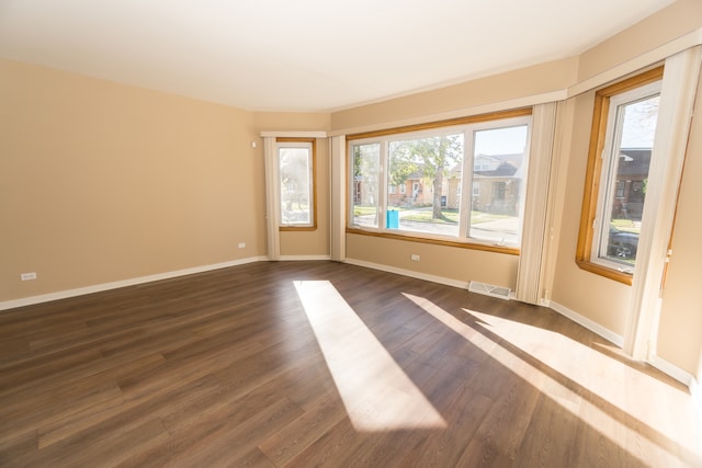 empty room with dark wood-type flooring