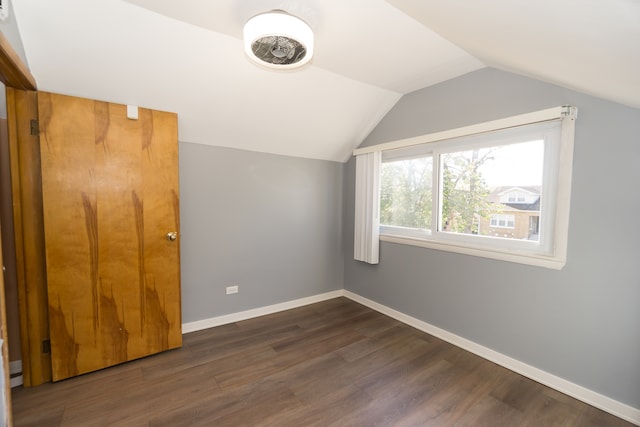 bonus room featuring dark wood-type flooring and vaulted ceiling