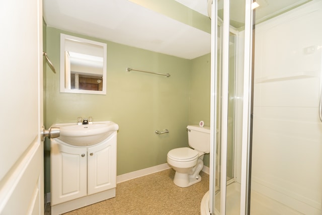 bathroom with vanity, toilet, and an enclosed shower