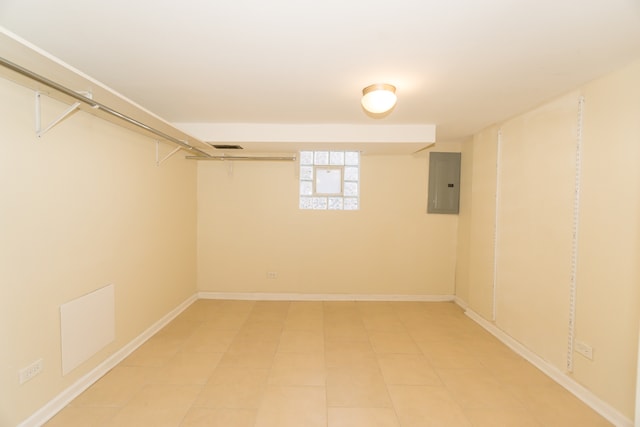 basement with electric panel and tile patterned flooring