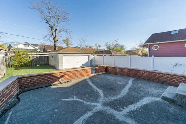 view of patio with an outbuilding and a garage